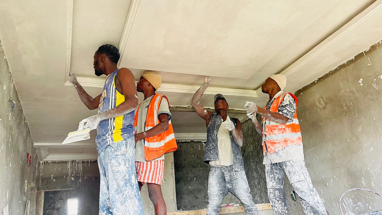 Jovert team applying decorative staff cornices to a ceiling